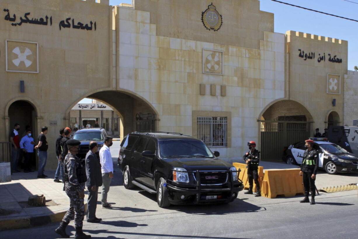 FILE - In this June 21, 2021 file photo, Bassem Awadallah, a former royal adviser, leaves a state security court in a vehicle after the first session of his closed-door trial, in Amman, Jordan. Awadallah, a Jordanian American, alleges he was tortured and fears for his life in Jordanian detention, Michael Sullivan, a U.S. lawyer said Sunday, July 11, 2021, on the eve of a verdict in the high-profile sedition trial linked to a rare public rift in the kingdom's ruling family.