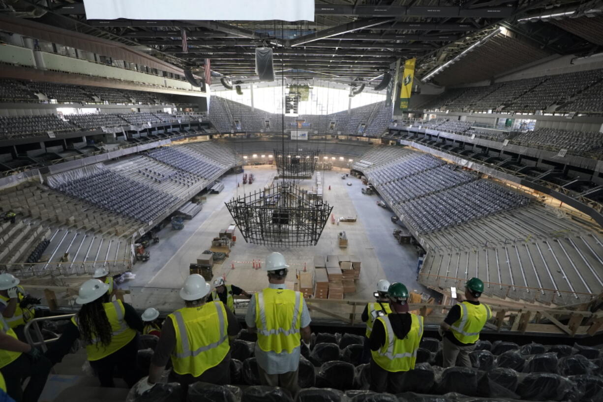 Visitors view the ice and seating areas of Climate Pledge Arena during a media tour of the facility. The arena will be the home of the NHL hockey team Seattle Kraken. (Ted S.