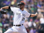 Colorado Rockies starting pitcher Austin Gomber works against the Seattle Mariners in the first inning of a baseball game Wednesday, July 21, 2021, in Denver.