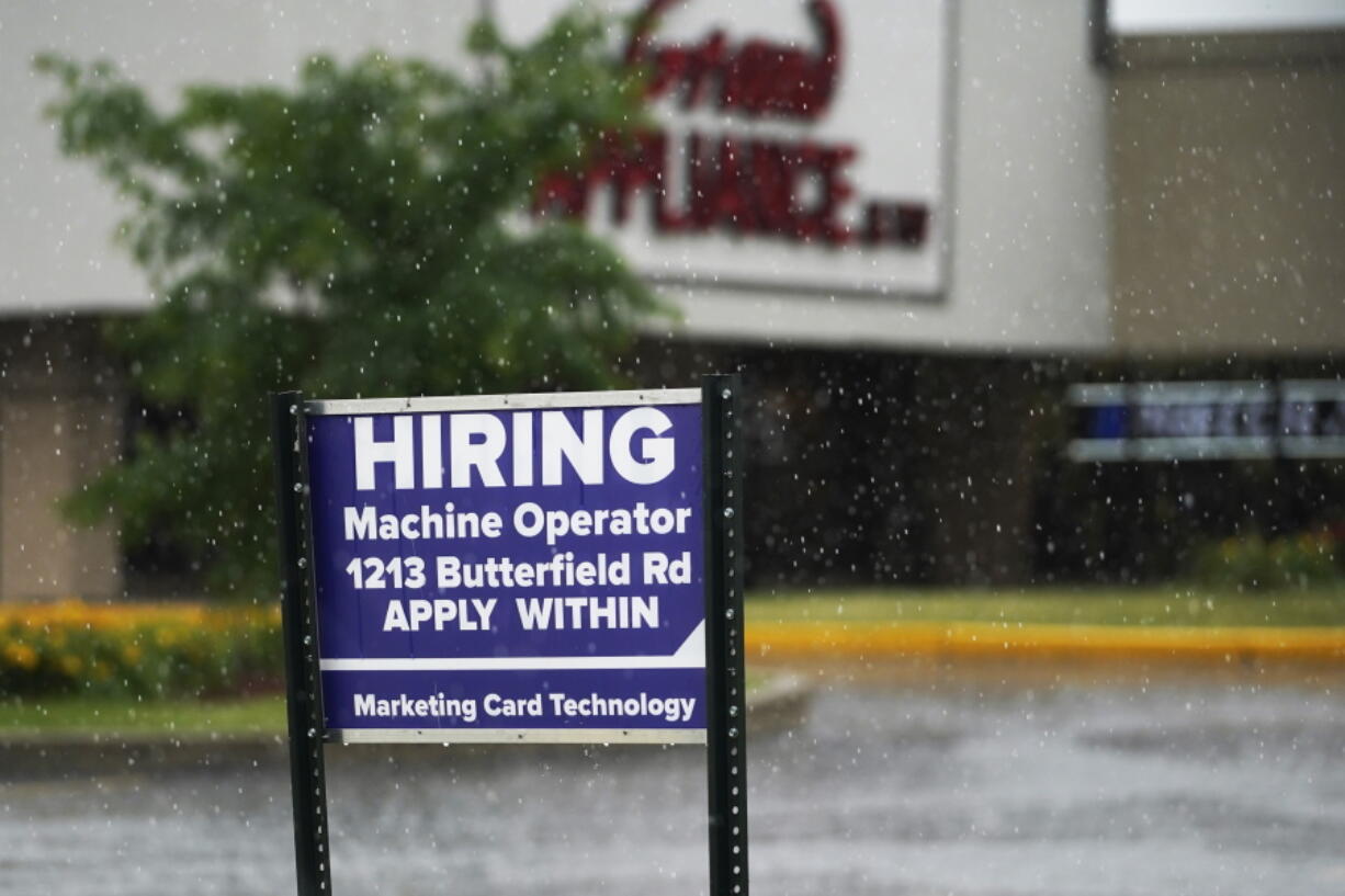 FILE - In this June 24, 2021 file photo, a hiring sign is displayed in Downers Grove, Ill. The number of Americans filing for unemployment benefits rose slightly last week even while the economy and the job market appear to be rebounding from the coronavirus recession with sustained energy. The government said, Thursday, July 8,  jobless claims increased by 2,000 from the previous week to 373,000.  (AP Photo/Nam Y.