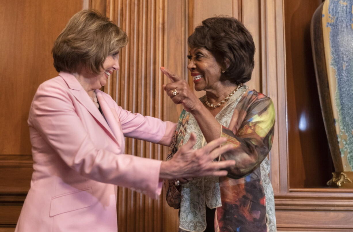 House Speaker Nancy Pelosi of Calif., left, and Rep. Maxine Waters, D-Calif., laugh after Waters told Pelosi a funny story, after Pelosi signed bill enrollments for Congressional Review Act Resolutions S. J. Res. 13, 14 and 15, Tuesday, June 29, 2021, on Capitol Hill in Washington.