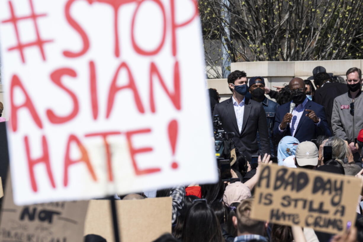 FILE - This March 20, 2021, file photo shows, U.S. Sens. Jon Ossoff, D-Ga., and Raphael Warnock, D-Ga., speaking during a "stop Asian hate" rally outside the Georgia State Capitol in Atlanta.  A national coalition of civil rights groups will release on Wednesday, July 28, 2021, a comprehensive, state-by-state review of hate crime laws in the United States. Members of the coalition say the report sets the stage for bolstering the efficacy of current law and addresses racial disparities in how the laws are enforced.