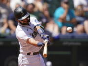 Seattle Mariners' Luis Torrens connects for a three-run home run against the Texas Rangers in the fourth inning of a baseball game Sunday, July 4, 2021, in Seattle.