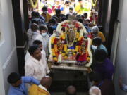 Sri Venkateswara Temple devotees and volunteers carry a deity back into the temple June 27 during Maha Kumbhabhishekam, a five-day Hindu rededication ceremony in Penn Hills, Pa. Built in the 1970s, the Sri Venkateswara Temple is the oldest major Hindu temple in the country.