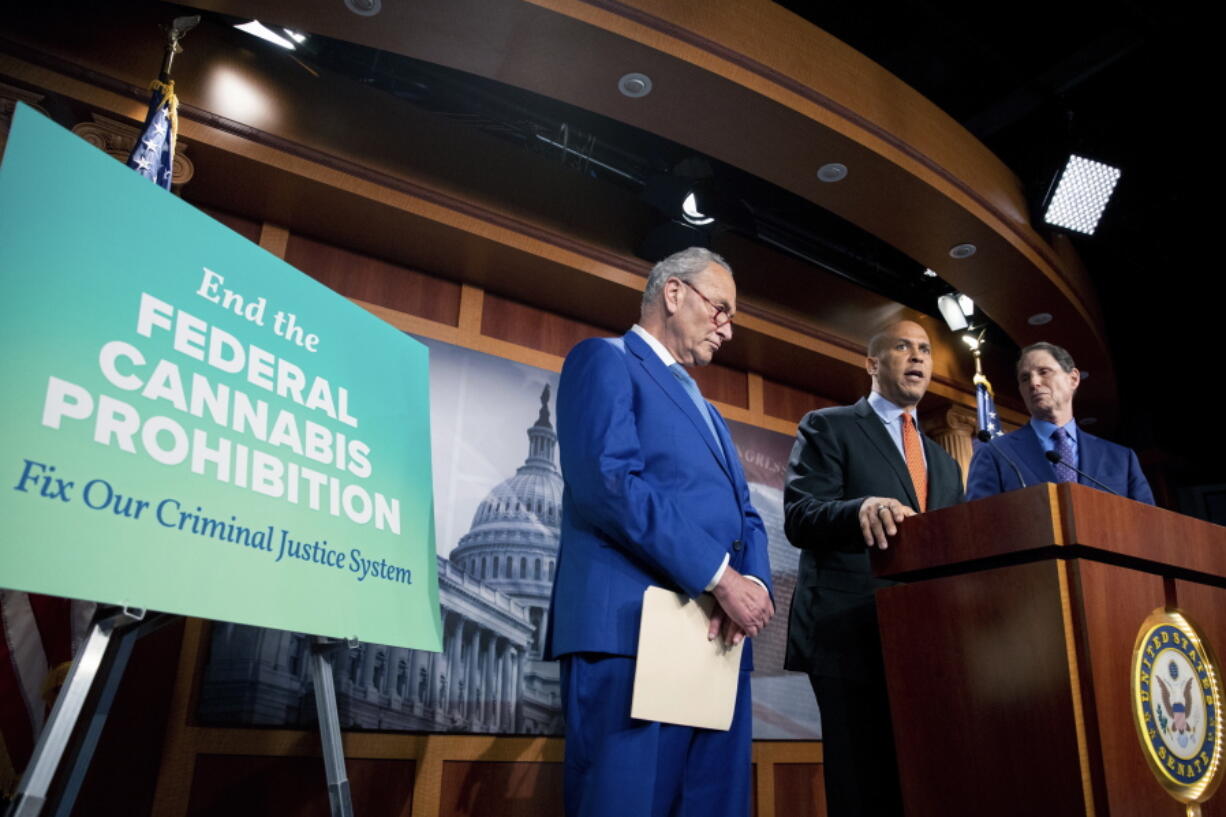 Senate Majority Leader Chuck Schumer, D-N.Y., from left, Sen. Cory Booker, D-N.J., and Sen. Ron Wyden, D-Ore., announce a draft bill that would decriminalize marijuana on a federal level on Capitol Hill in Washington, on Wednesday.