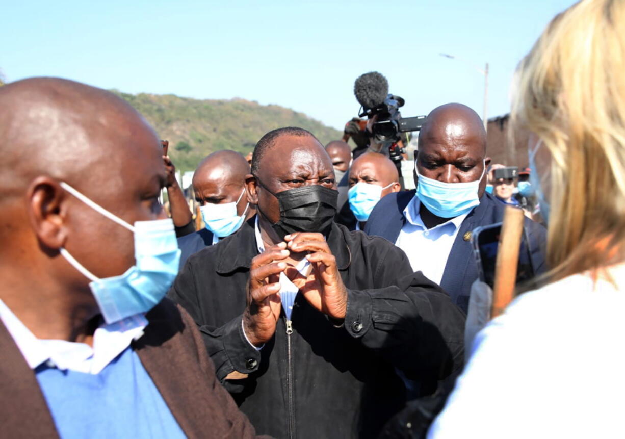 South African President Cyril Ramaphosa, visits an area in Durban, South Africa, Friday, July 16, 2021 which was badly affected by unrest in the past week. South Africa's army has begun deploying 25,000 troops to assist police in quelling weeklong riots and violence sparked by the imprisonment of former President Jacob Zuma and causing a shortage of basic foods.