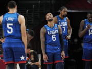 United States' Damian Lillard (6), Kevin Durant (7), and Draymond Green (16) their loss to France in wait for play to resume during their loss to France in a men's basketball preliminary round game at the 2020 Summer Olympics, Sunday, July 25, 2021, in Saitama, Japan.