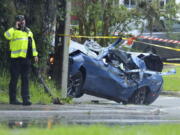 Law enforcement investigators in the scene of a fatal car crash on Roosevelt Blvd. in the Ortega neighborhood of Jacksonville, Fla. during the strong winds from Tropical Storm Elsa, Wednesday, July 7, 2021.