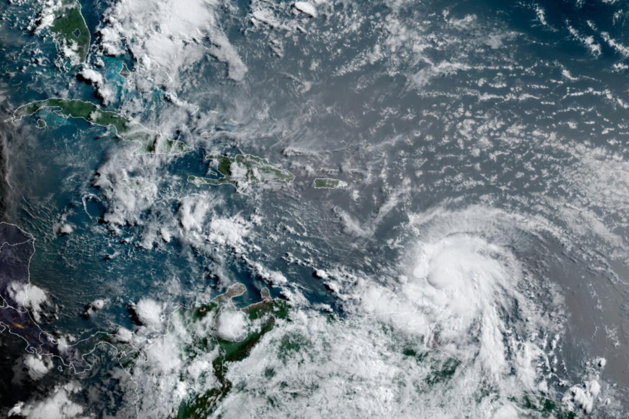 This satellite image provided by the National Oceanic and Atmospheric Administration shows Hurricane Elsa moving through the Caribbean, over Barbados, Tuesday, July 2, 2021, at 12:00 Z (8am a.m. ET). Elsa was expected to pass near the southern coast of Hispaniola on Saturday and to move near Jamaica and portions of eastern Cuba on Sunday.