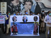 In this June 25, 2021 photo, Former Afghan interpreters hold placards during a demonstrations against the US government, in front of the US Embassy in Kabul, Afghanistan. The Biden administration says it will evacuate about 2,500 Afghans who worked for the U.S. government and their families to a military base in Virginia pending approval of their visas. The administration notified Congress on Monday that the Afghans will be housed at the Fort Lee Army base south of Richmond starting next week.