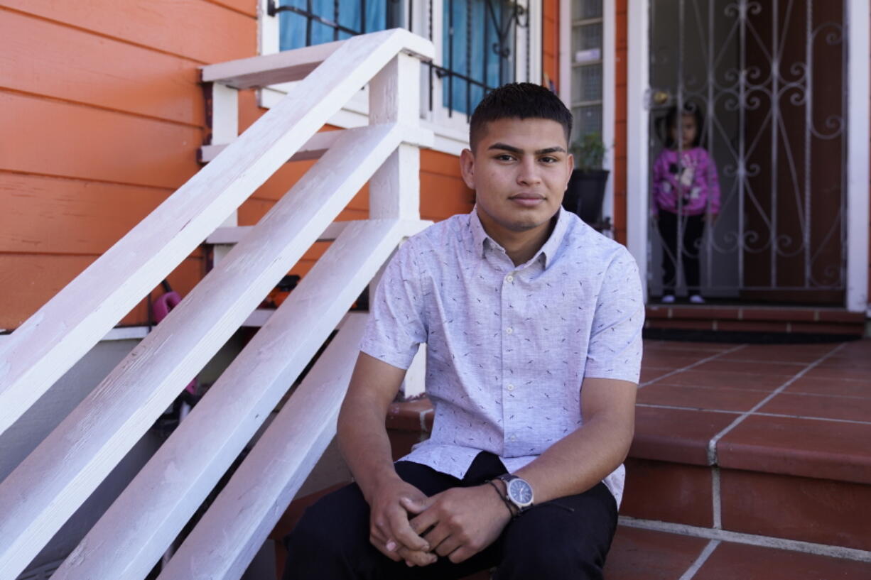 Alan Reyes Picado poses outside his home, as his niece looks on from behind, in San Francisco, California, Friday, July 9, 2021. Reyes arrived in the United States in Feb. 2021, after receiving death threats in Nicaragua and is asking for asylum.