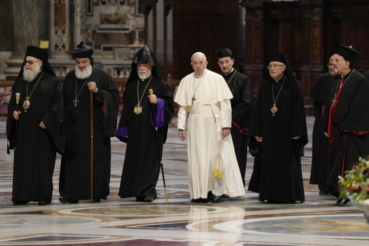 The Patriarch of the Syriac Orthodox Church, Moran Mor Ignatius Aphrem II, second from left, the head of the Catholicosate of the Great House of Cilicia of the Armenian Apostolic Church, Aram I, third from left, Pope Francis, fourth from left, Cardinal Bechara Boutros al-Rahi, firfth from left, Patriarch of Antioch and All the East for the Syriac Catholic Church, Ignatius Youssef III Younan, right, arrive in St. Peter's Basilica to attend a prayer for Lebanon at the Vatican, Thursday, July 1, 2021.