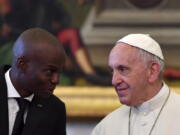 FILE - In this Jan. 26, 2018 file photo, Haiti President Jovenel Moise meets with Pope Francis during a private audience at the Vatican. Pope Francis is sending condolences from the hospital to Haiti following what he said was the "heinous assassination" of its president.