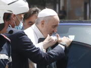 FILE - In this July 14, 2021 file photo, Pope Francis stops to greet police that escorted him as he arrives at the Vatican after leaving the hospital 10 days after undergoing planned surgery to remove half his colon. The Vatican on Wednesday, July 21, 2021, released a grueling travel itinerary for Pope Francis' first post-surgery foreign trip, scheduling around-the-clock encounters and hop-scotching, in-country flights for his Sept. 12-15 visit to Hungary and Slovakia.