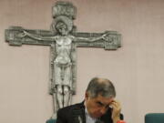 FILE - In this Friday, Sept. 25, 2020 file photo, Cardinal Angelo Becciu looks down as he meets the media during a press conference in Rome. The Vatican's criminal tribunal on Saturday, July 3, 2021 indicted 10 people, including a cardinal, and four companies on charges including extortion, abuse of office and fraud in connection with the Secretariat of State's 350 million-euro investment in a London real estate venture. Also indicted was another once-powerful Holy See official, Cardinal Angelo Becciu, who helped engineer the initial London investment when he was the chief of staff in the Secretariat of State.