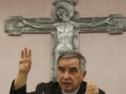 FILE - In this Friday, Sept. 25, 2020 file photo, Cardinal Angelo Becciu talks to journalists during press conference in Rome. A trial is slated to begin on Tuesday, July 27, 2021 within the Vatican City's imposing walls of 10 defendants, including once-powerful cardinal Becciu, in a case based on a sprawling probe into the allegedly criminal management of the Holy See's portfolio of assets, including donations by countless Catholics from the pews.