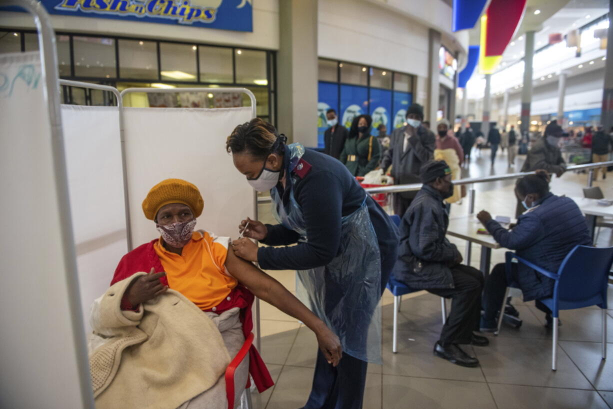 FILE - In this July 6, 2021, file photo, a patient receives a Johnson & Johnson vaccine against COVID-19 in Hammanskraal, South Africa. New infections in South Africa rose to record levels in recent days, part of a rapid rise across the continent, and experts say the surge here has not yet peaked. South Africa reimposed several restrictions, and its vaccination drive is finding its feet after several stumbles. But even as the campaign gathers pace, experts say it's too late to reduce the deadly impact of the current spike.