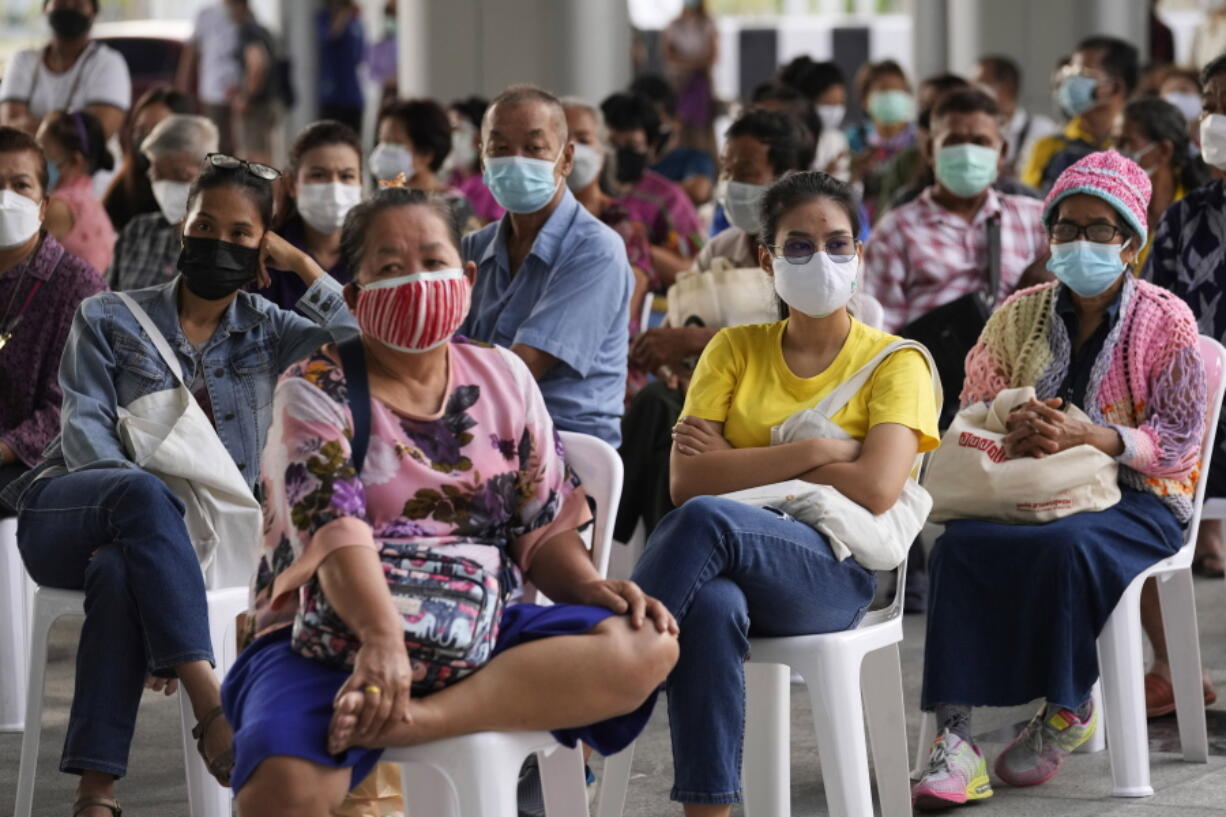 Residents wait to receives shots of the AstraZeneca COVID-19 vaccine at the Central Vaccination Center in Bangkok, Thailand, Thursday, July 15, 2021. As many Asian countries battle against a new surge of coronavirus infections, for many their first, the slow-flow of vaccine doses from around the world is finally picking up speed, giving hope that low inoculation rates can increase rapidly and help blunt the effect of the rapidly-spreading delta variant.