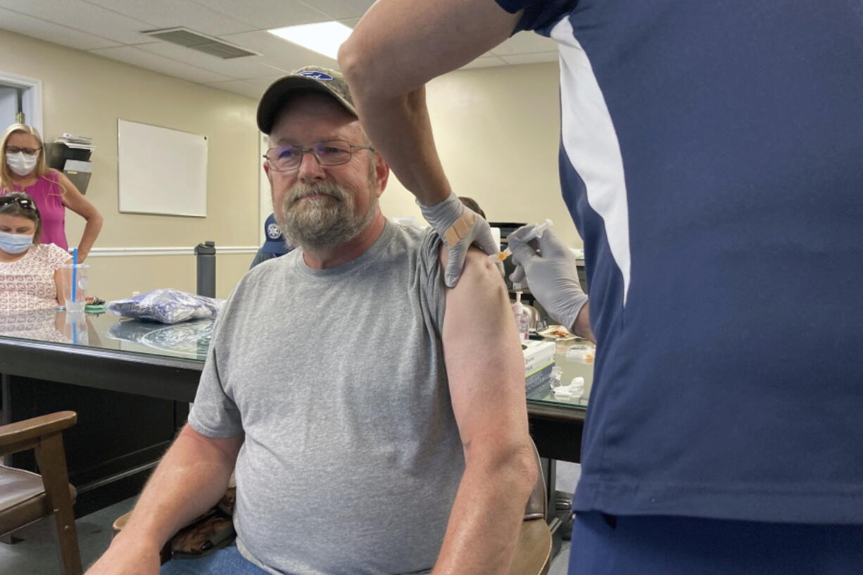 John Rogers receives a second dose of the COVID-19 vaccine in Taylorsville, Ky., on Thursday, June 17, 2021. Rogers waited months after becoming eligible for the COVID-19 vaccine. It was only after talking with friends that the retiree was persuaded to get the shot. "They said, 'You know, the vaccine may not be 100%, but if you get COVID, you're in bad shape,'" Rogers said.