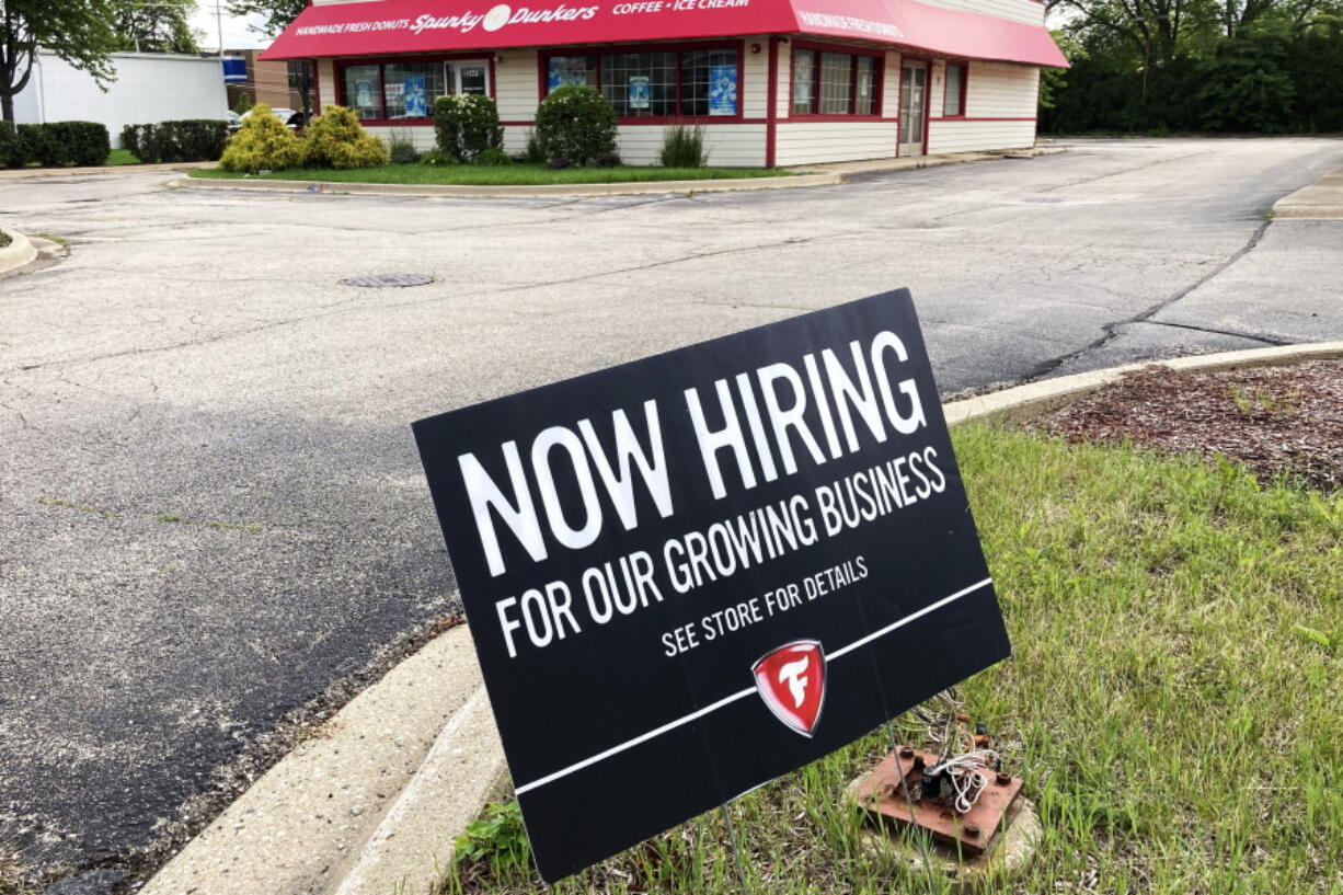 A hiring sign is displayed Wednesday at the Firestone Complete Auto Care store in Arlington Heights, Ill. (Nam Y.