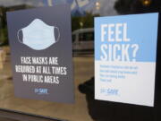 Face mask requirements are posted at the various entrances at the Rose E. McCoy Auditorium where COVID-19 vaccinations are being offered on the Jackson State University campus in Jackson, Miss., Tuesday, July 27, 2021. The university has similar signage posted throughout the campus. The Centers for Disease Control and Prevention announced new recommendations that vaccinated people return to wearing masks indoors in parts of the U.S. where the coronavirus is surging and also recommended indoor masks for all teachers, staff, students and visitors to schools, regardless of vaccination status. (AP Photo/Rogelio V.