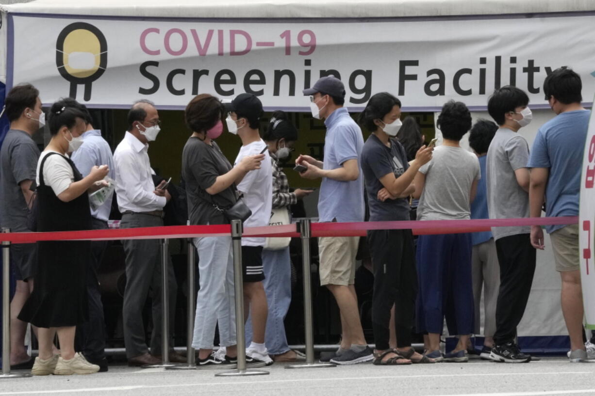 People queue in line to wait for the coronavirus testing at a Public Health Center in Seoul, South Korea, Friday, July 9, 2021. South Korea will enforce its strongest social distancing restrictions in the greater capital area starting next week as it wrestles with what appears to be the worst wave of the coronavirus since the start of the pandemic.