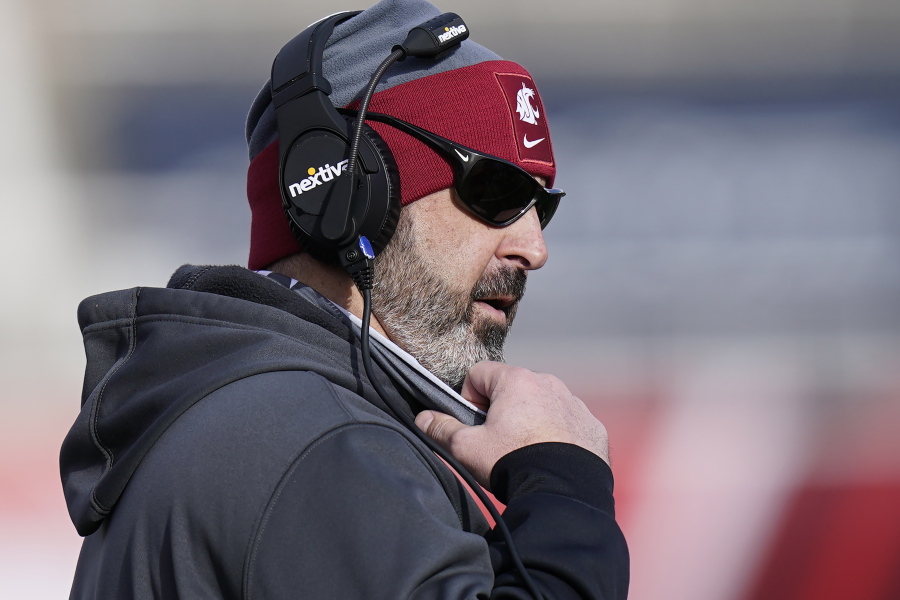 FILE - Washington State head coach Nick Rolovich looks on during the first half of an NCAA college football game against Utah in Salt Lake City, in this Saturday, Dec. 19, 2020, file photo. Rolovich has become the story of Pac-12 media day even though he won't be in attendance. Rolovich's announcement last week he has chosen not to receive a COVID-19 vaccination has divided his fan base and seemingly his school as one of the colleges requiring students and staff to be vaccinated before the start of classes this fall.