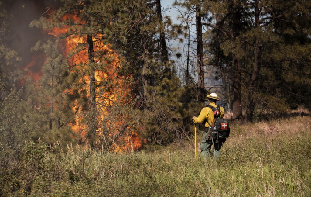 Elements of the Andrus Road Fire are seen in the late afternoon on Monday, July 5, 2021 in Cheney, Wash. The wildfire in Central Washington has expanded to burn 7,900 acres of land and authorities have called for additional evacuations. Gov. Jay Inslee on Tuesday declared a state of emergency throughout Washington relating to the growing risk of wildfires, including a statewide prohibition on most outdoor and agricultural burning through Sept. 30.