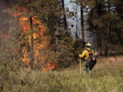 Elements of the Andrus Road Fire are seen in the late afternoon on Monday, July 5, 2021 in Cheney, Wash. The wildfire in Central Washington has expanded to burn 7,900 acres of land and authorities have called for additional evacuations. Gov. Jay Inslee on Tuesday declared a state of emergency throughout Washington relating to the growing risk of wildfires, including a statewide prohibition on most outdoor and agricultural burning through Sept. 30.