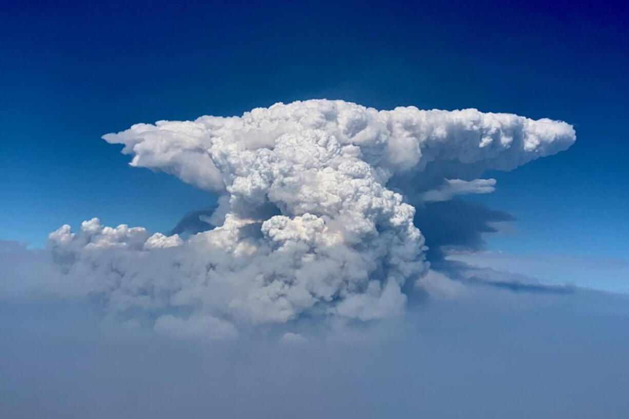 In this photo taken with a drone provided by the Bootleg Fire Incident Command, a pyrocumulus cloud, also known as a fire cloud, is seen over the Bootleg Fire in southern Oregon on Wednesday, July 14, 2021. Smoke and heat from a massive wildfire in southeastern Oregon are creating "fire clouds" over the blaze -- dangerous columns of smoke and ash that can reach up to 30,000 feet (9,144 meters) and are visible for more than 100 miles (160 kilometers) away. Authorities have put these clouds at the top of the list of the extreme fire behavior they are seeing on the Bootleg Fire, the largest wildfire burning in the U.S.