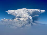 In this photo taken with a drone provided by the Bootleg Fire Incident Command, a pyrocumulus cloud, also known as a fire cloud, is seen over the Bootleg Fire in southern Oregon on Wednesday, July 14, 2021. Smoke and heat from a massive wildfire in southeastern Oregon are creating "fire clouds" over the blaze -- dangerous columns of smoke and ash that can reach up to 30,000 feet (9,144 meters) and are visible for more than 100 miles (160 kilometers) away. Authorities have put these clouds at the top of the list of the extreme fire behavior they are seeing on the Bootleg Fire, the largest wildfire burning in the U.S.