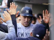 New York Yankees' Aaron Judge is congratulated after scoring against the Seattle Mariners during the first inning of a baseball game Wednesday, July 7, 2021, in Seattle.