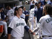 Seattle Mariners starting pitcher Logan Gilbert is congratulated by J.P. Crawford (3) after throwing against the New York Yankees through seven innings of a baseball game Thursday, July 8, 2021, in Seattle.