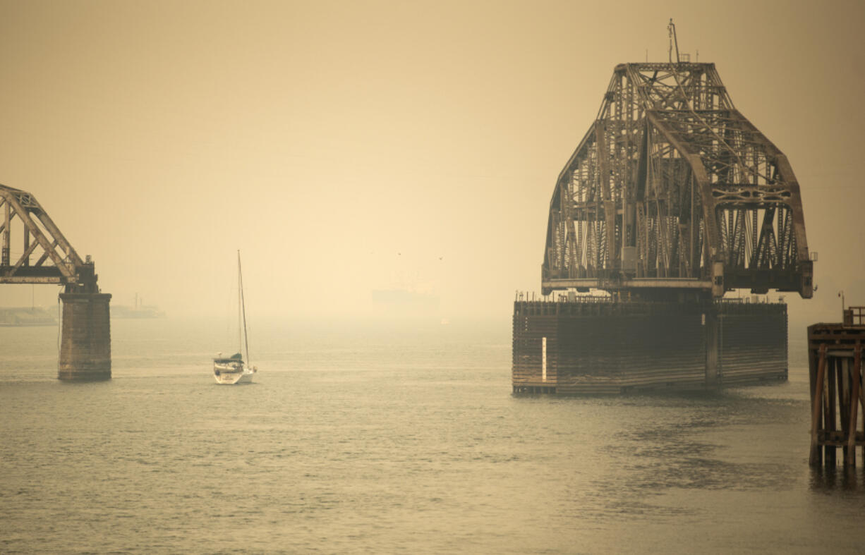 A sailboat makes its way past the railroad bridge in Vancouver through the smoke on Sept. 10, 2020. Smoke events in Vancouver tend to be weather-dependent, occurring when east winds bring smoke from elsewhere in the state to the western half.