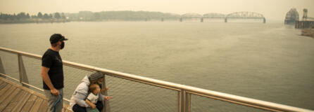 Brent McCarthy, left, and Marissa Matthews, right, play on the Vancouver Waterfront pier with their son Xavier, 2, on Sept. 10, 2020. The family evacuated from their home just outside of Salem, Ore., two days earlier to escape the smoke and fire risk. Longer and hotter fire seasons increase the likelihood of smoke finding its way to Vancouver.