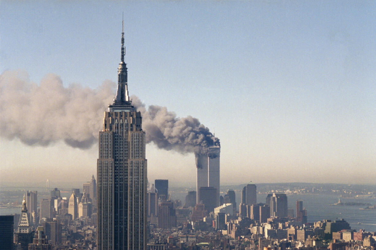 The World Trade Center burns behind the Empire State Building on Sept. 11, 2001.