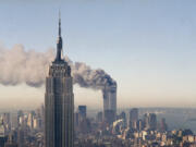 The World Trade Center burns behind the Empire State Building on Sept. 11, 2001.