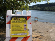 A toxic-algae warning sign is posted next to Lacamas Lake in Camas on July 20, 2020.