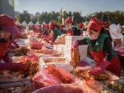 Volunteers take part in a kimchi-making festival in Seoul in 2018.