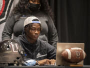 Tobias Merriweather, center, is joined by his mother, Beverly Merriweather, as he announces his college choice.