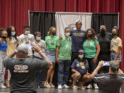 Tobias Merriweather, an incoming senior at Union High School, in navy blue, joins loved ones on stage at Union High School after announcing he will play college football at Notre Dame on Wednesday afternoon, Aug. 4, 2021.