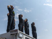 EMTÕs and firefighters from Clark County Fire District 6 stand atop a firetruck and salute as a funeral procession for Clark County Sheriff's Sgt. Jeremy Brown drives north on I-5 on Tuesday, Aug. 3, 2021, at the NE 139th Street overpass in Vancouver.