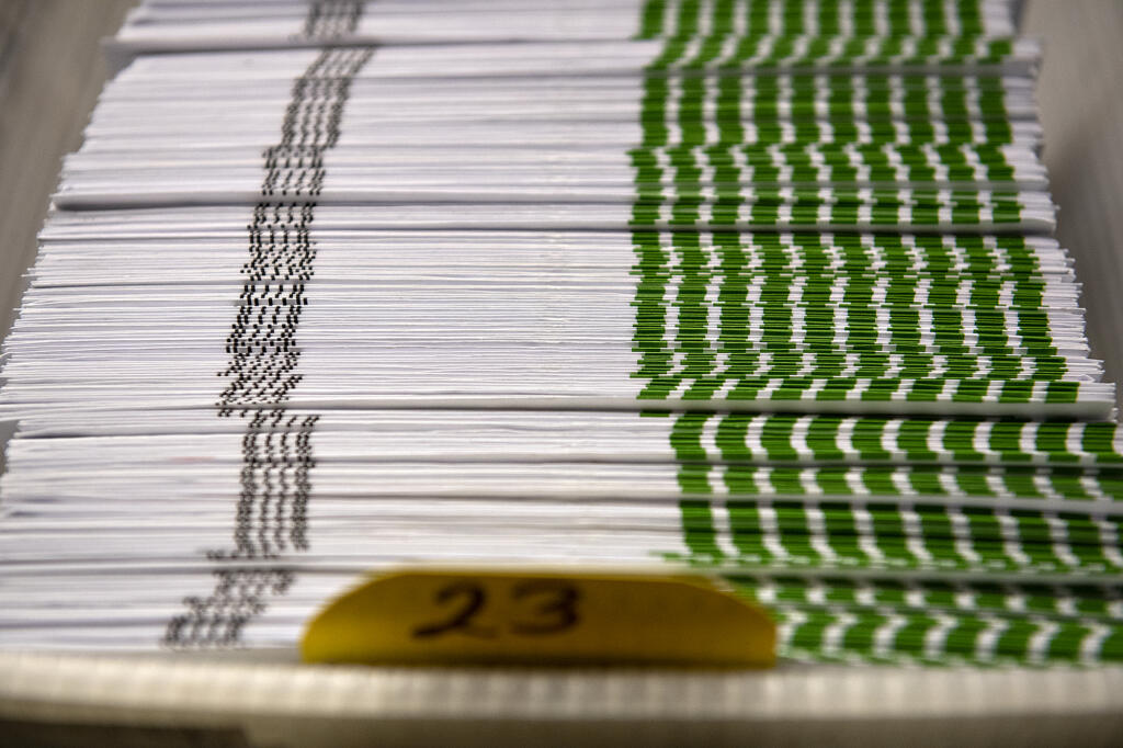 A stack of ballots go through the sorting process at the Clark County Elections Office on Tuesday morning, Aug. 3, 2021.