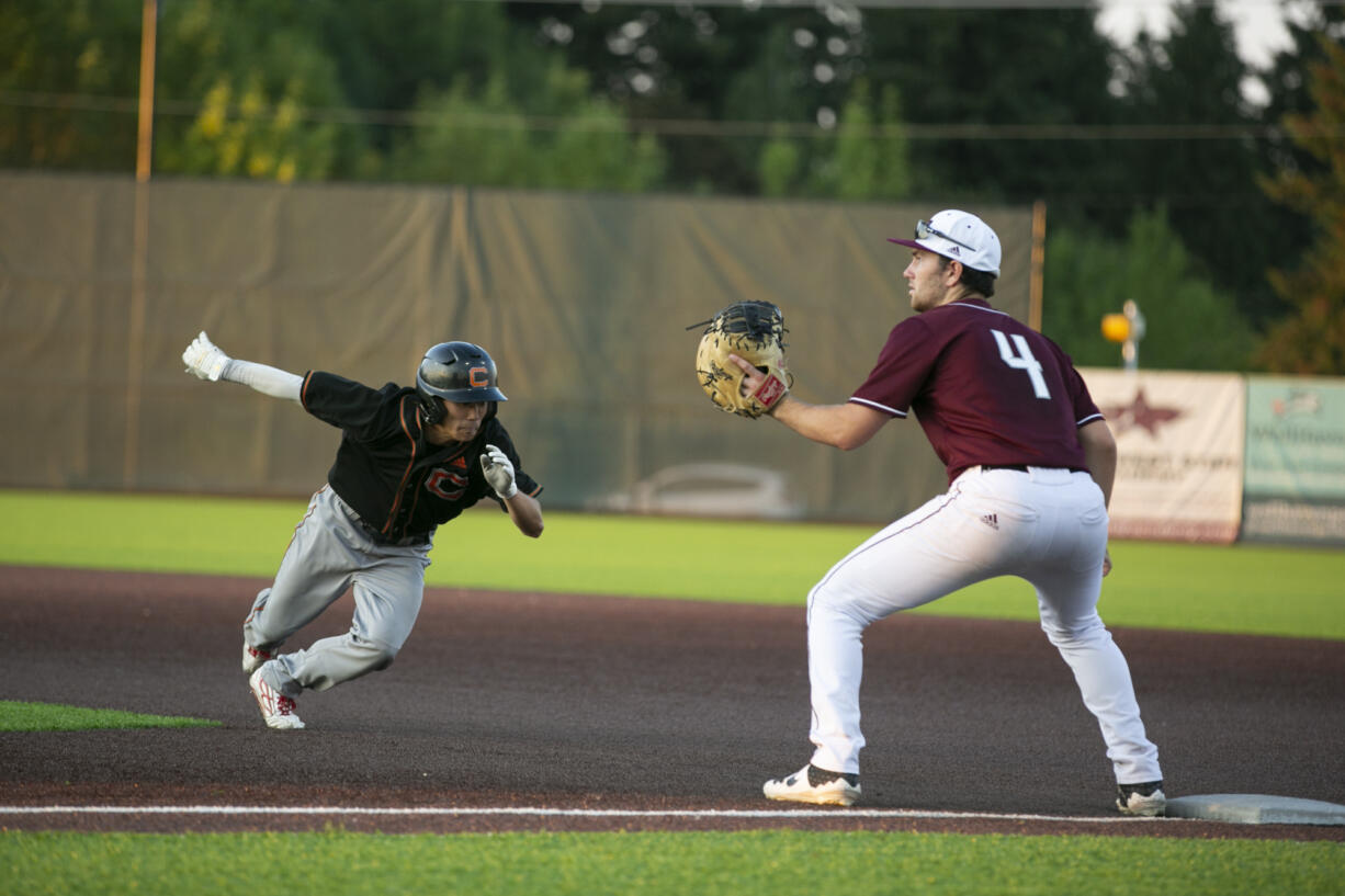 Ridgefields' Doyle Kayne waits for the ball as Cowlitz' Rikuu Nishida returns to first base at Ridgefield Outdoor Recreation Complex on Wednesday, August 4, 2021.