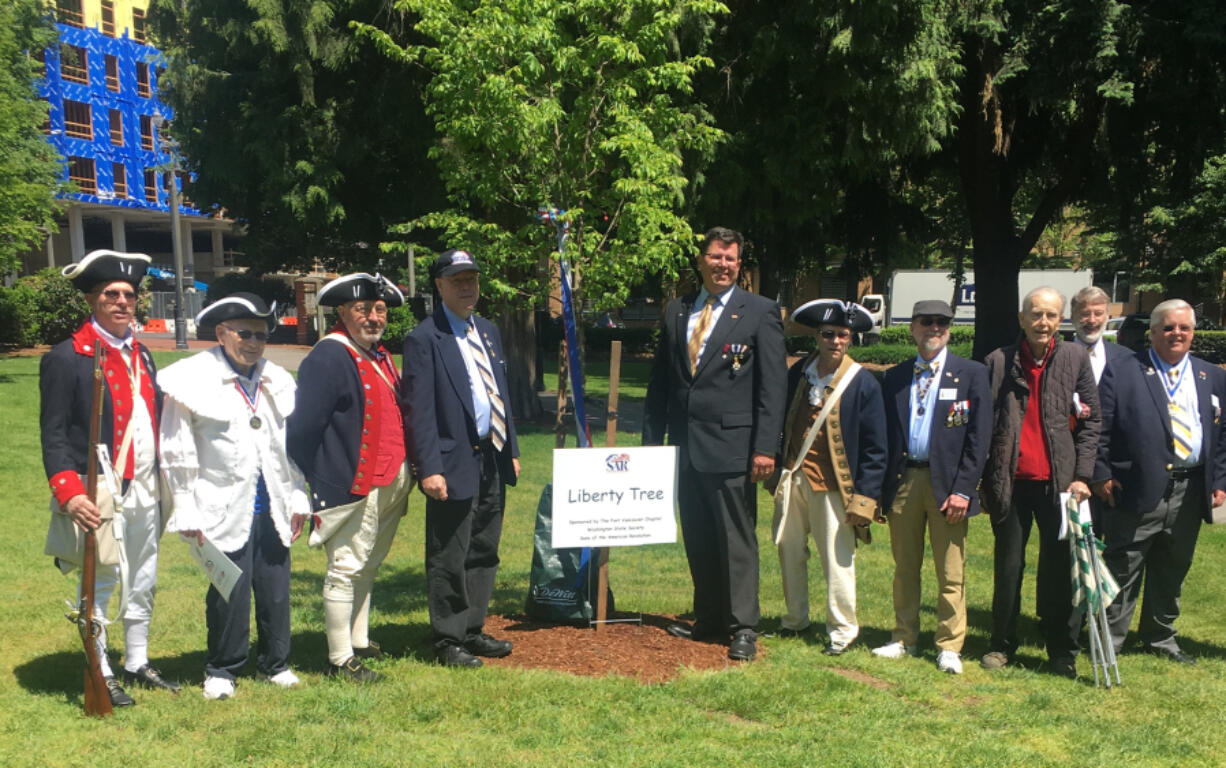 ESTHER SHORT: From left are Sons of the American Revolution members Larry Heckethorne; George Vernon; Larry Peck; Andrew Brewer; Paul Ocker; Carl Gray; Keith Weissinger, president; Alfred Folkerts; Greg Lucas, vice president; and Jeff Lightburn, president of the Fort Vancouver Chapter, at a tree planting earlier this year.