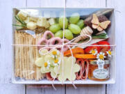 Charcuterie, including this elegant offering from Board and Bubbles, can elevate a picnic from fun to memorable.