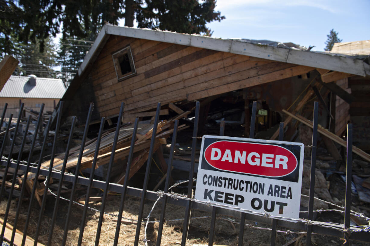 The house at 6114 N.E. 112th Ave., dubbed the "meth mansion," is seen Tuesday morning partly demolished. Code violations and nuisance complaints over the property have plagued the neighborhood for years. The owner's attorney said he abandoned the idea of remodeling in favor of tearing it all down and starting new.