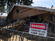 The house at 6114 N.E. 112th Ave., dubbed the "meth mansion," is seen Tuesday morning partly demolished. Code violations and nuisance complaints over the property have plagued the neighborhood for years. The owner's attorney said he abandoned the idea of remodeling in favor of tearing it all down and starting new.