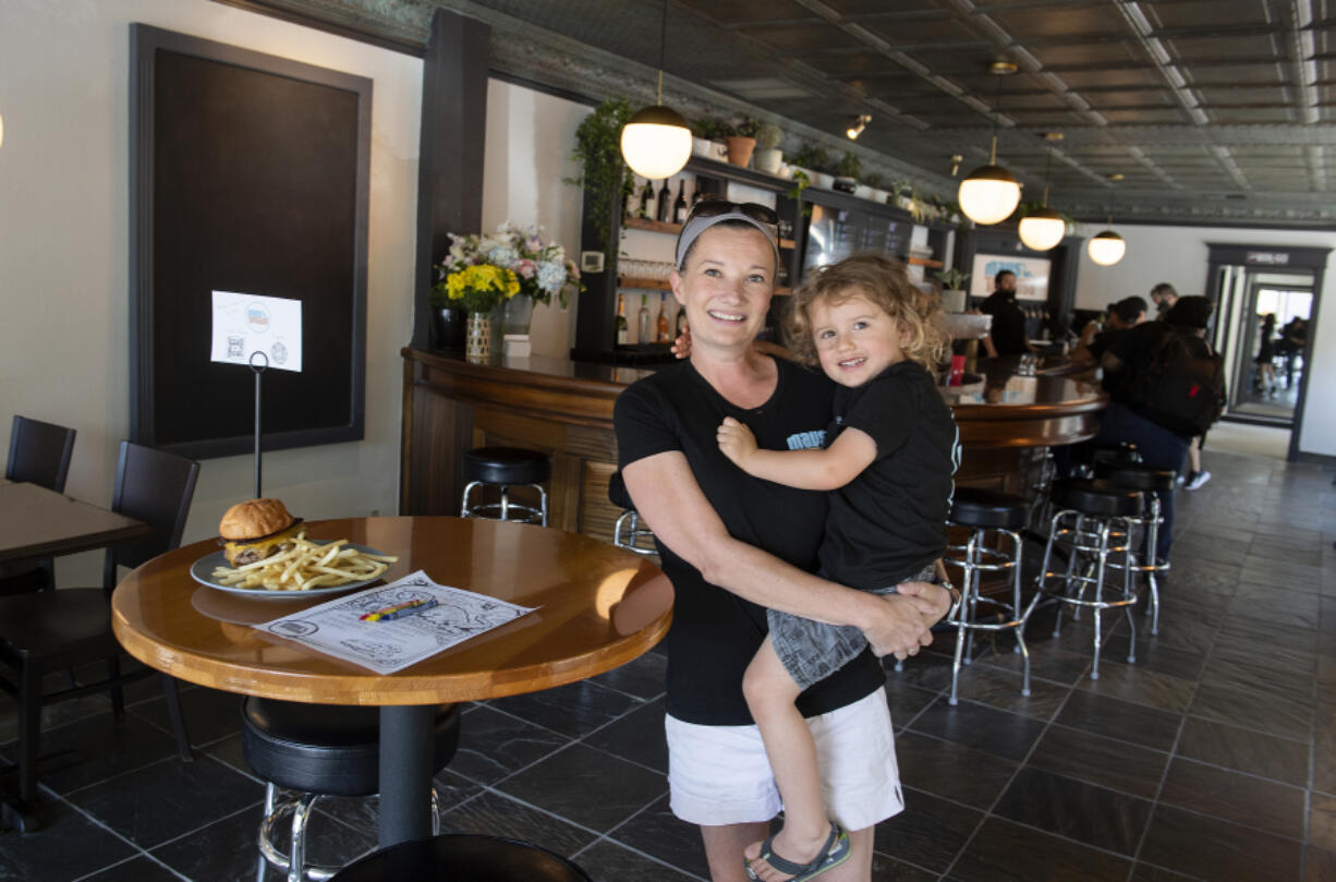 Mav's Taphouse owner Calista Crenshaw pauses for a portrait with her son, Maverick Britt in downtown Vancouver on Wednesday afternoon. The new taphouse is named in honor of Maverick.