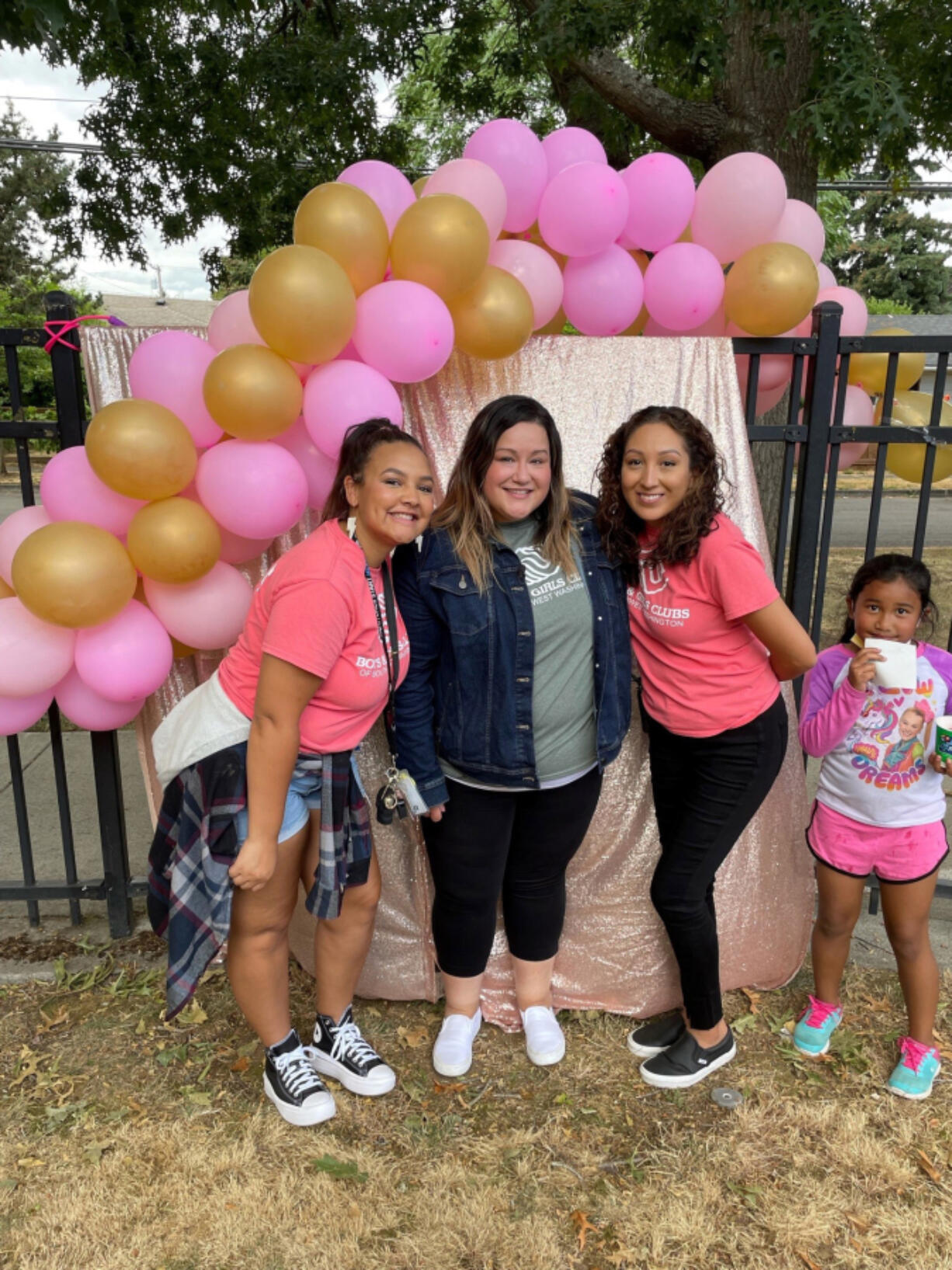 ROSE VILLAGE: Ashley Jones, center, poses for a photo with Boys & Girls Clubs Washington Elementary Club employees Mikaela Bolds, left, and Maria Ramirez, right, and club member Rolynda, far right.